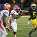 Michigan running back Justice Hayes stiff arms in the second half of the game against Illinois on Saturday. Daniel Brenner I AnnArbor.com